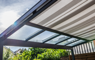 sun beaming through a glass and fabric awning