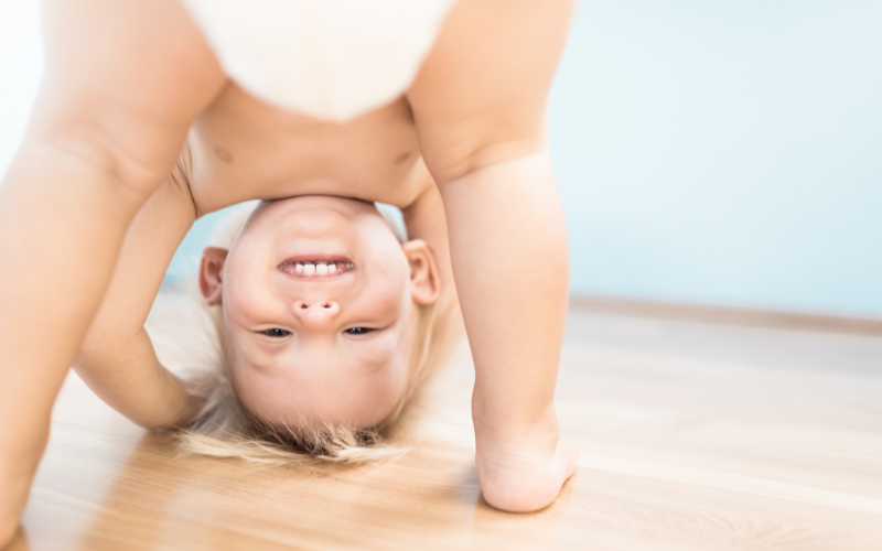 horizontal website images (4) child safe shutters - a toddler bent over in just a nappy look back through its legs at the camera with a cheeky grin