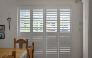 white full height shutters in a dining room